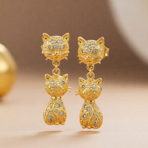 Gold cat earrings with crystal embellishments, styled in a luxury drop design featuring cat heads and bodies… 