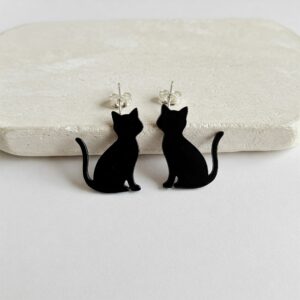 Minimalist black cat earrings shaped like cat silhouettes, designed as elegant stud earrings with clean lines… 
