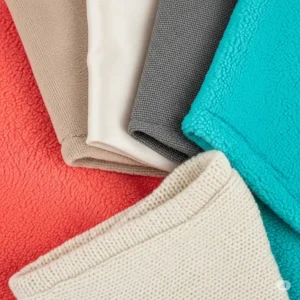 A close-up view of various soft and skin-friendly fabrics, showcasing materials suitable for hairless cat clothes to prevent irritation.