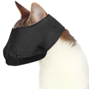 A cat wearing a black nylon fabric muzzle that covers its eyes and mouth for safety during nail trimming or vet visits.