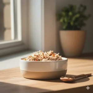 A portion of wet, shredded rabbit cat food in a clean ceramic bowl, ready to be served.
