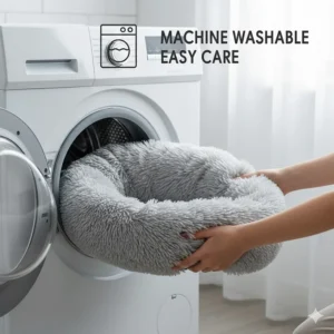 An icon graphic showing the cat bed doughnut being placed into a washing machine, highlighting it as a machine washable product.
