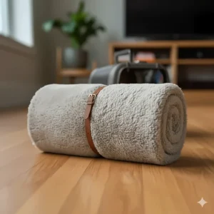 The warm, durable pet blanket for a cat neatly rolled up, showing its compact, portable size for travel.