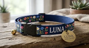Floral printed nylon personalized cat collar with a safety breakaway clip and custom metal charm.